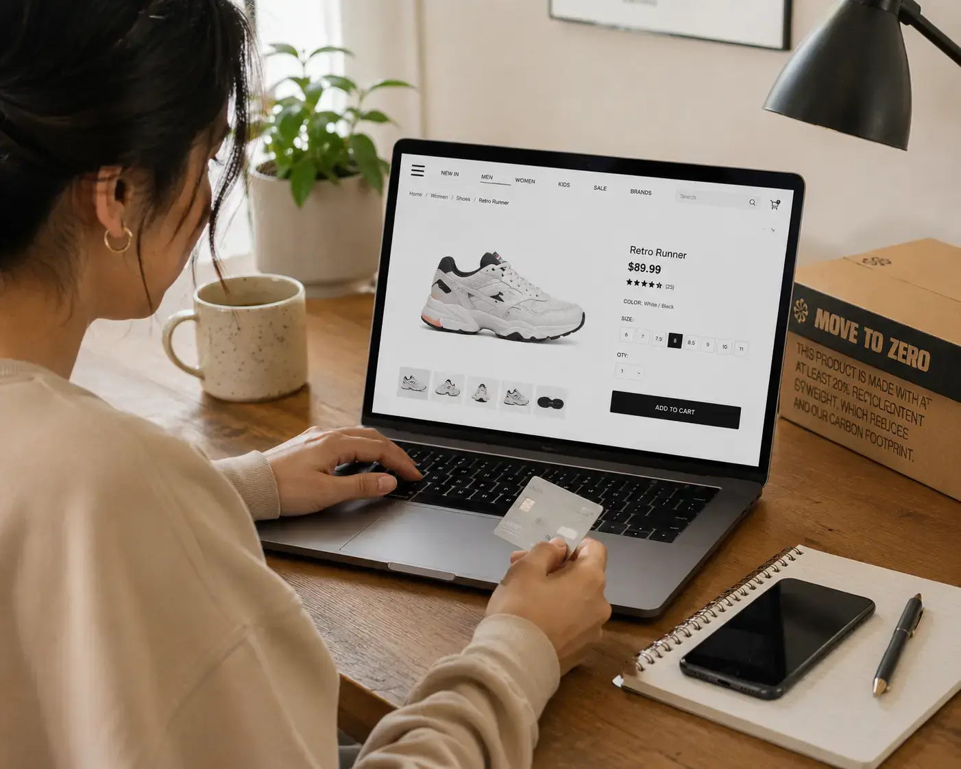 Woman shopping for trainers on laptop