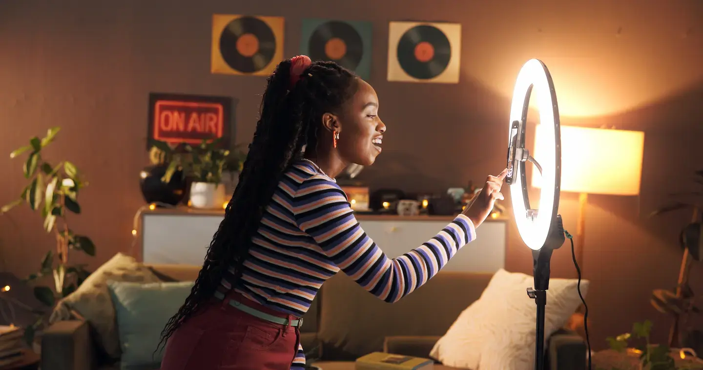 Woman setting up selfie cam and lighting