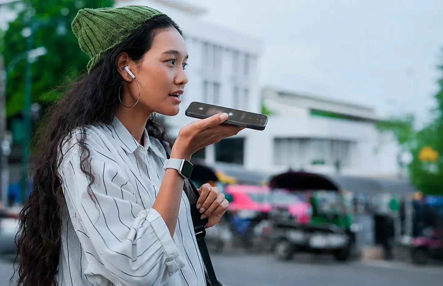 Woman speaking into phone speaker
