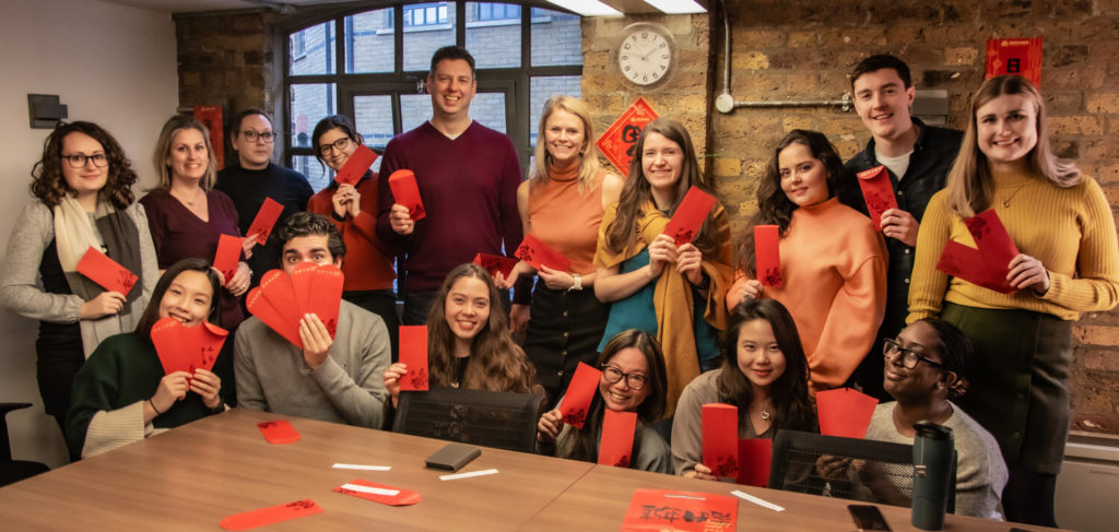 Chinese New Year - Group of staff holding red envelopes