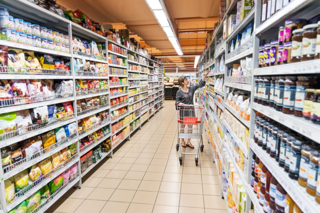 Woman shopping for FMCG products at a supermarket