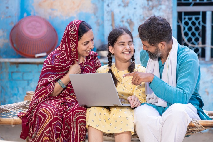 Family sitting together with a laptop